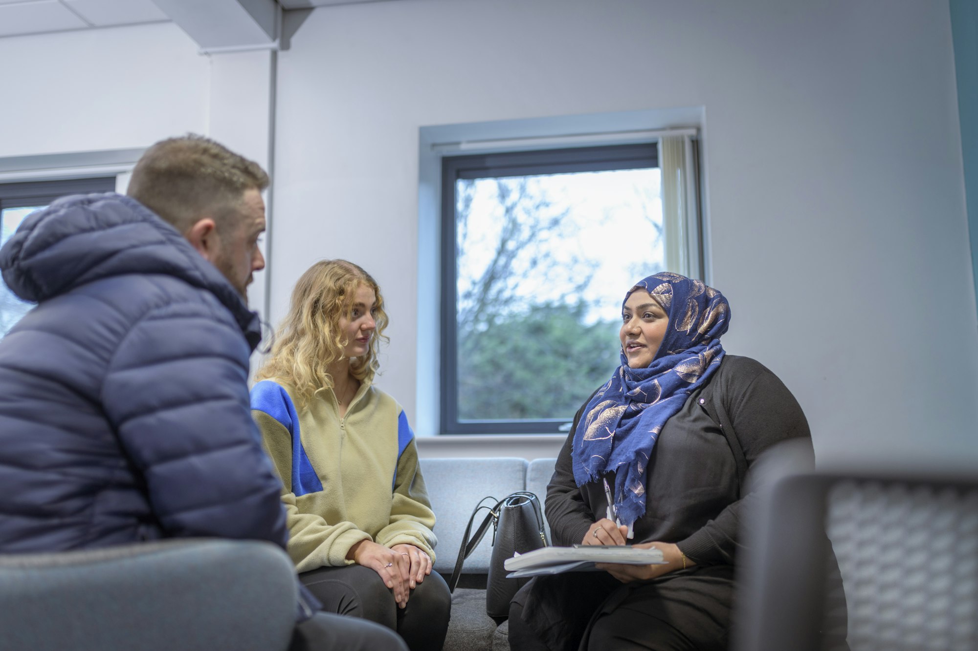 Foster care social worker in meeting with foster parents