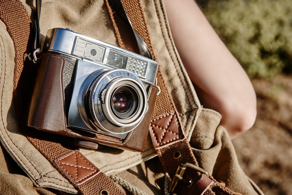 Carrying a vintage camera on the countryside. Film photography