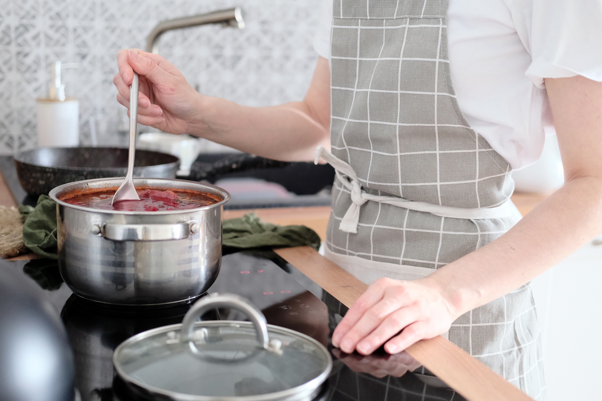 Woman cooking soup in the kitchen