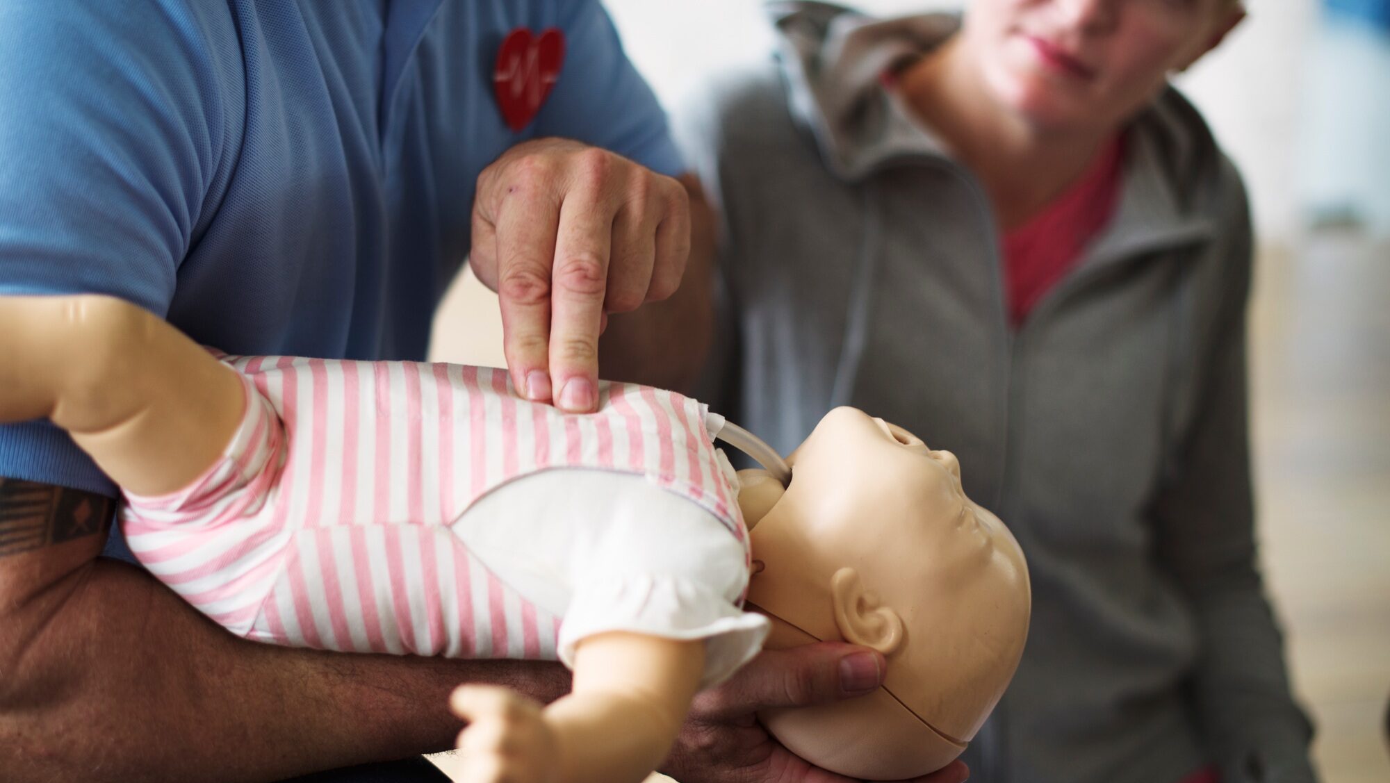 CPR first aid training on a doll infant