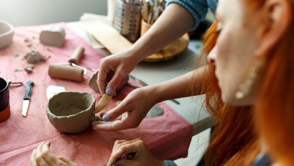 Pottery workshop class. A pottery crafts dish from a raw clay. Creating ceramics