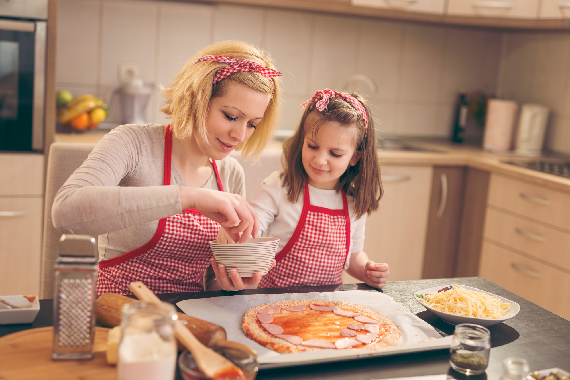 Putting salami on the pizza dough